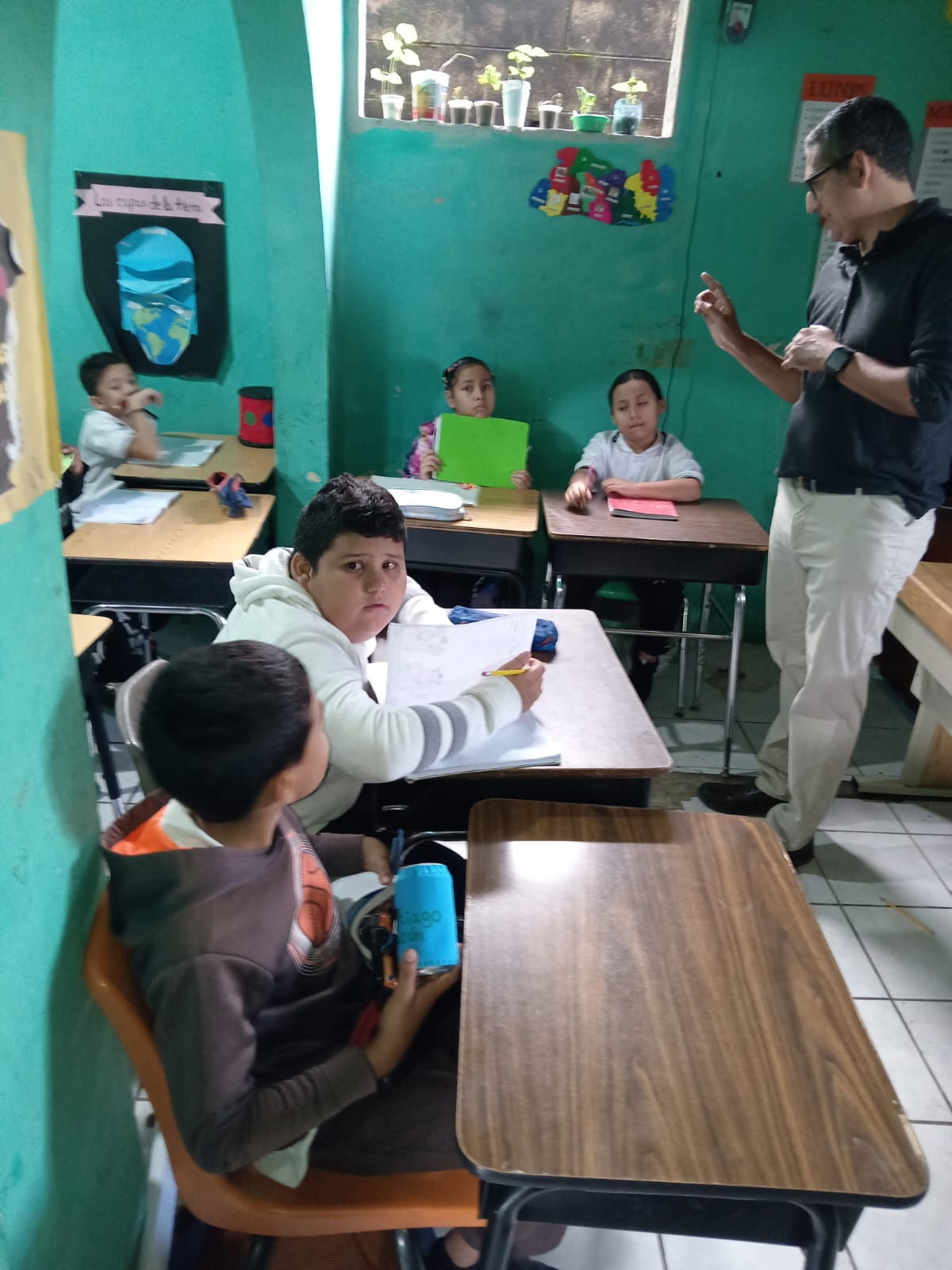 Students in La Palma, El Salvador using desks once used in Missouri classrooms.