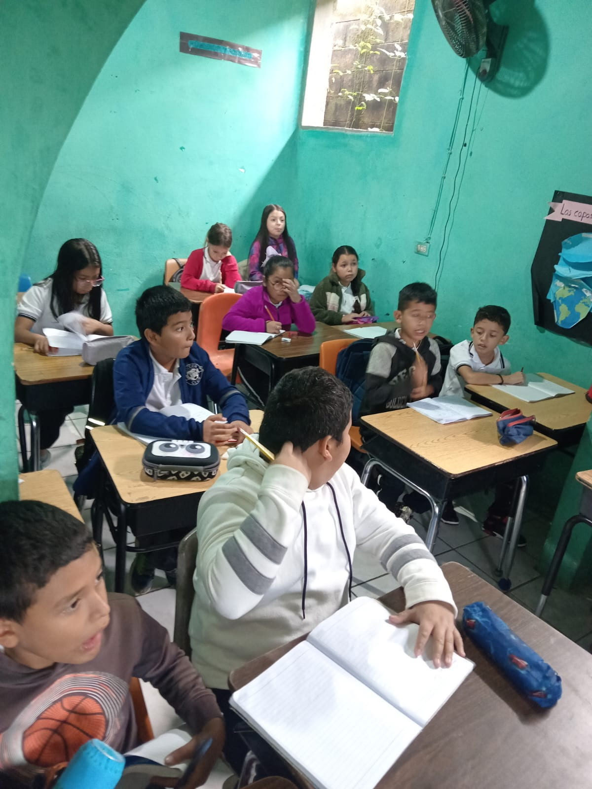 Students in La Palma, El Salvador using desks once used in Missouri classrooms.